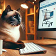 Siamese cat sitting at desk with computer showing online shopping cart