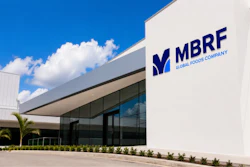 Modern white corporate building with MBRE Global Foods Company logo and dark-tinted windows under blue sky