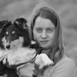 Young girl holding a black and white Rough Collie dog outdoors in black and white portrait photography